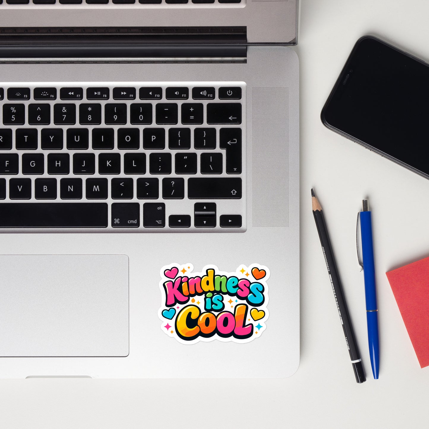Colorful bubble letter sticker reading Kindness is Cool with vibrant hearts and sparkles on a black background.