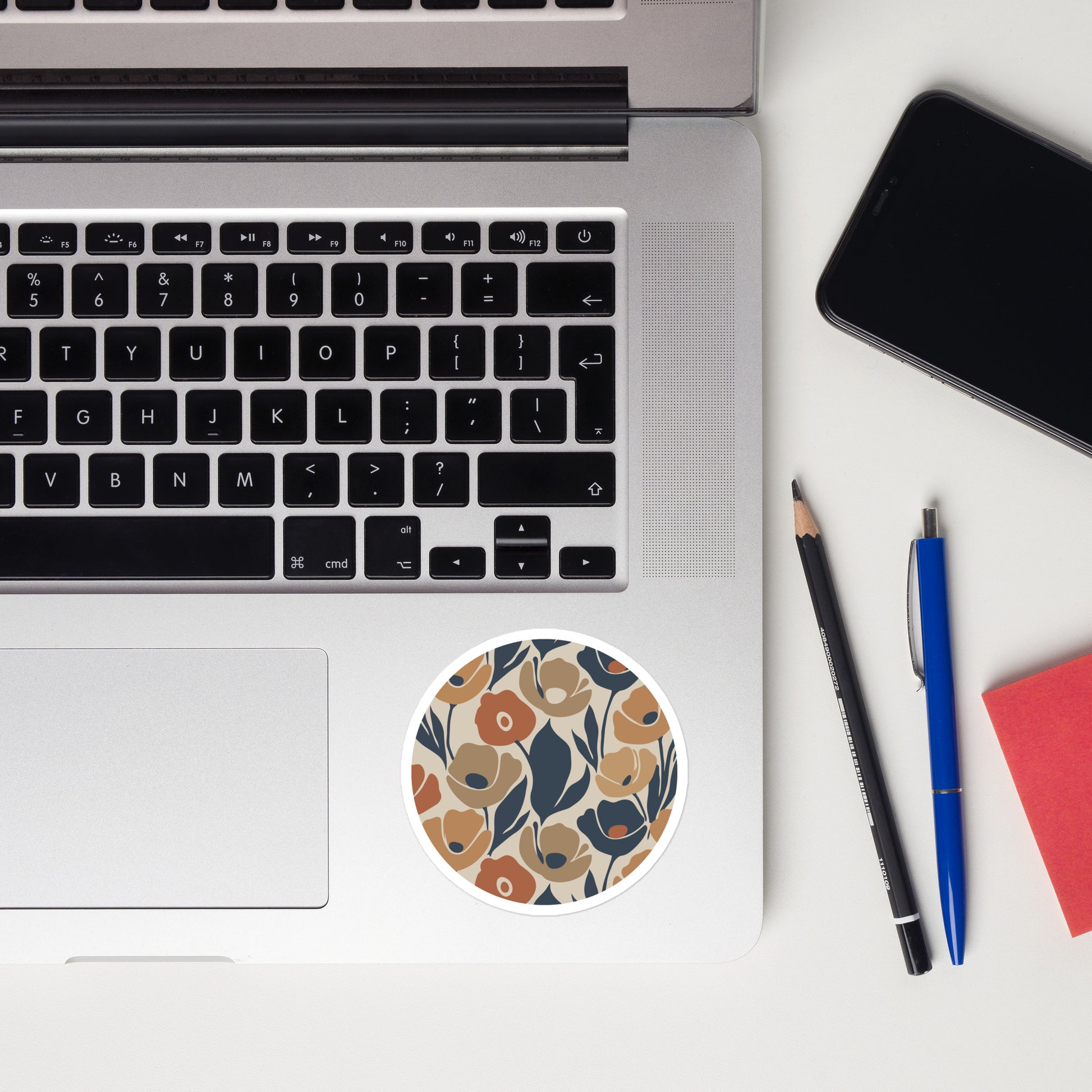 Durable vinyl sticker featuring a retro floral pattern with organic flower shapes in terracotta and navy blue.