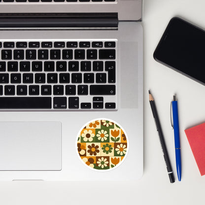 Durable vinyl sticker featuring a 1970s retro floral grid pattern with groovy flowers in orange, brown, and green.