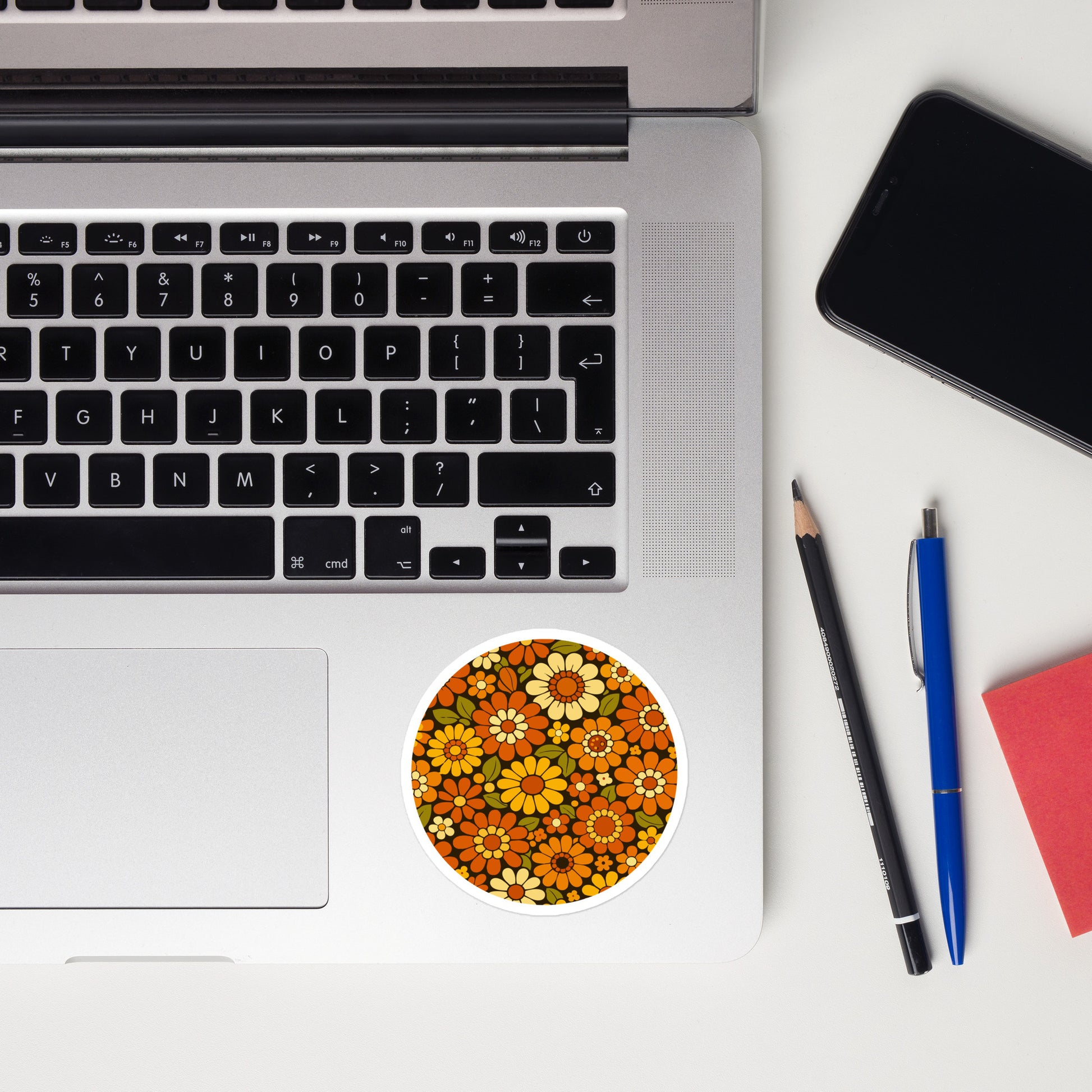 Retro 70s floral pattern vinyl sticker featuring orange, yellow, and cream daisies on a dark brown background.