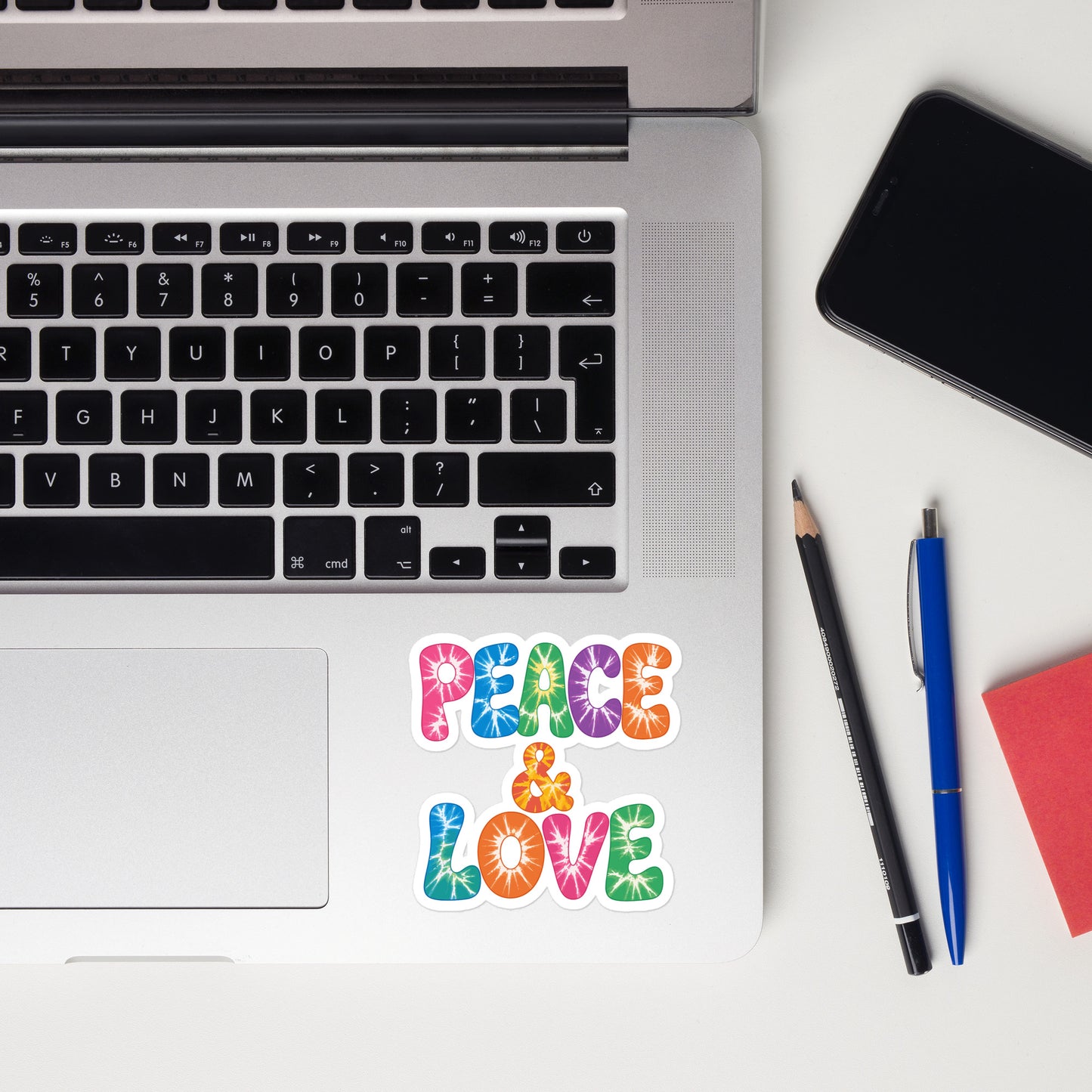 Colorful tie-dye Peace and Love lettering vinyl sticker in retro 60s and 70s vibrant rainbow font. Faroutgoods