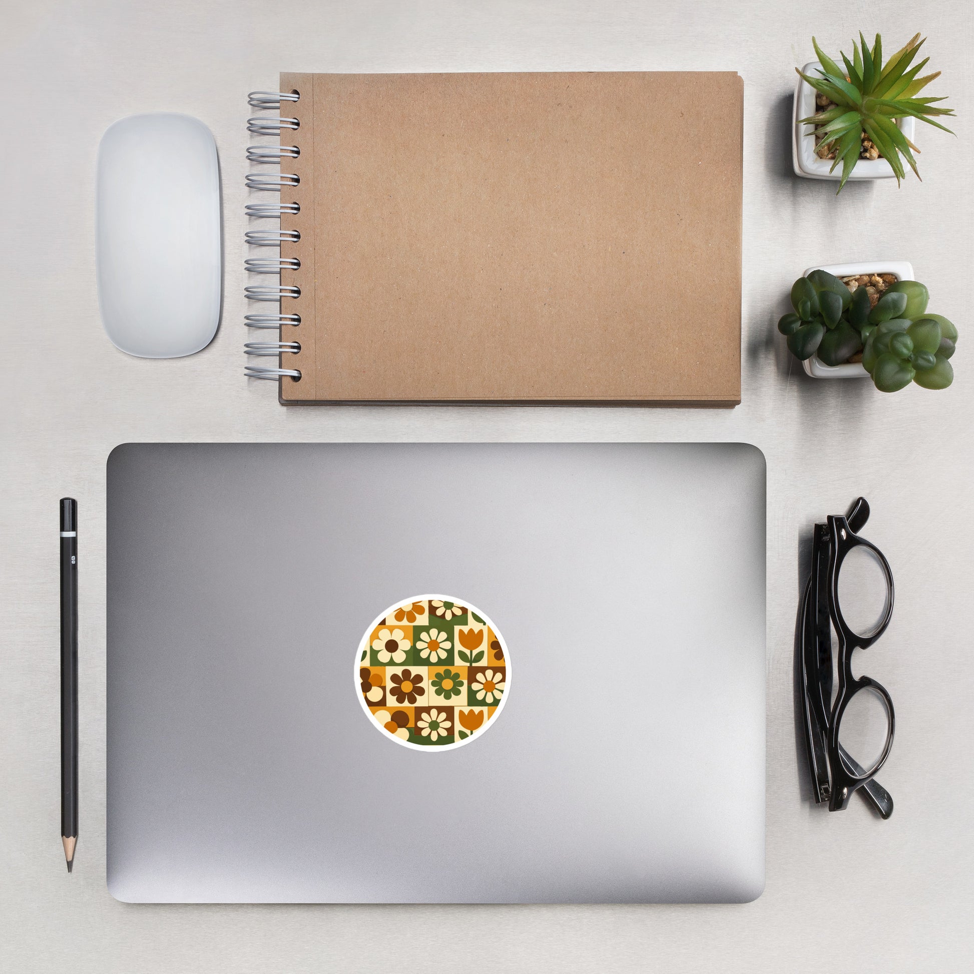 Durable vinyl sticker featuring a 1970s retro floral grid pattern with groovy flowers in orange, brown, and green.