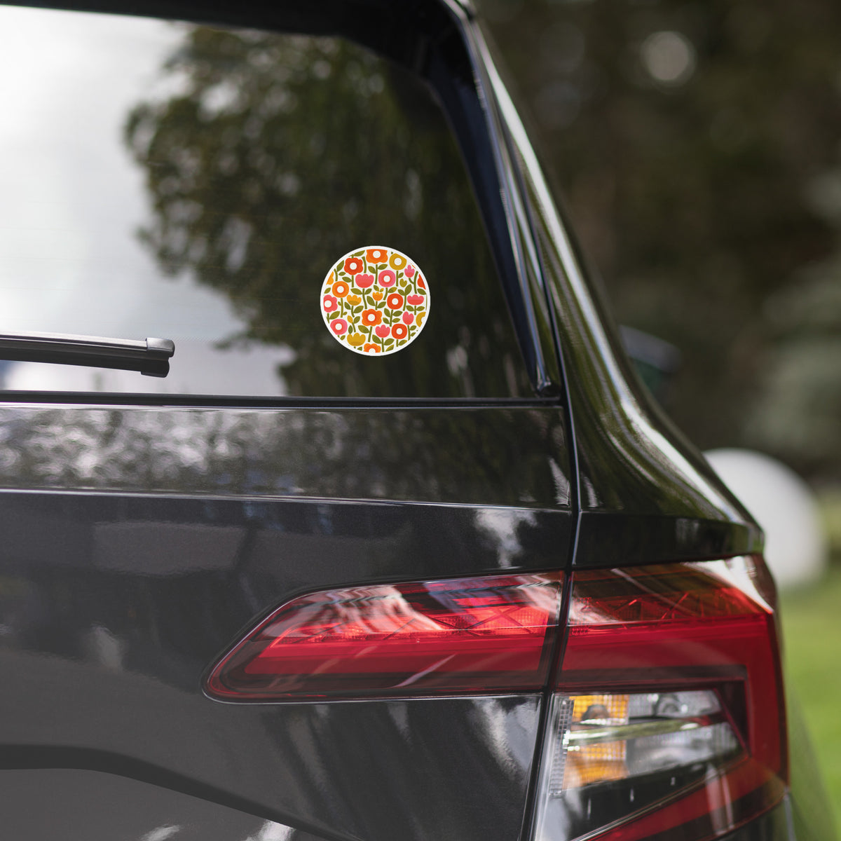 Retro 1970s flower power pattern vinyl sticker featuring geometric orange, pink, and yellow flowers with green leaves