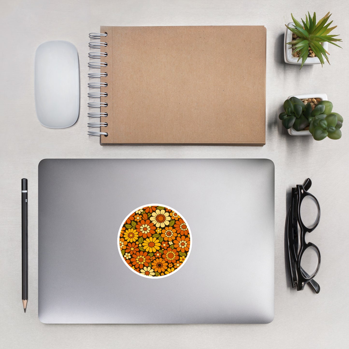 Retro 70s floral pattern vinyl sticker featuring orange, yellow, and cream daisies on a dark brown background.