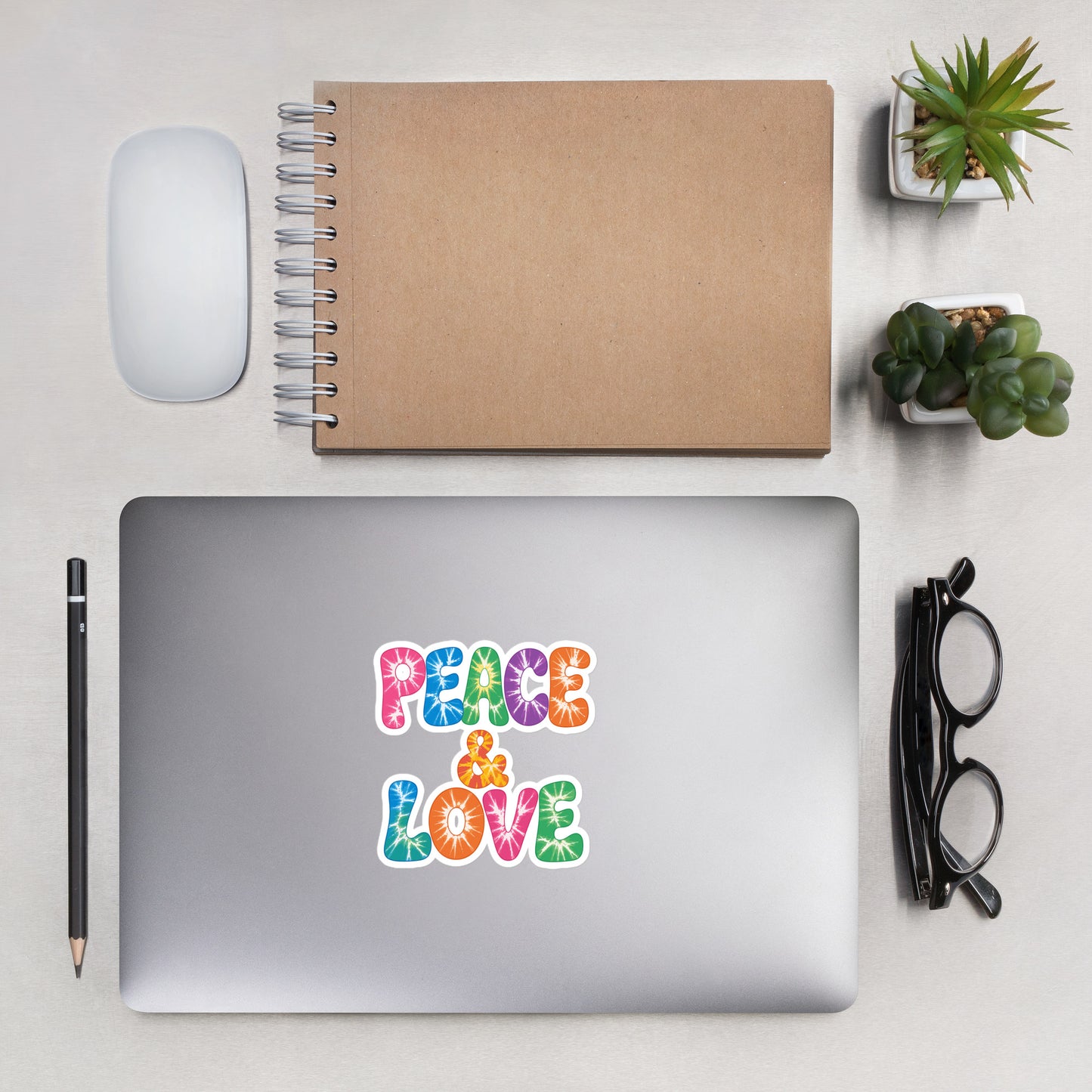 Colorful tie-dye Peace and Love lettering vinyl sticker in retro 60s and 70s vibrant rainbow font. Faroutgoods