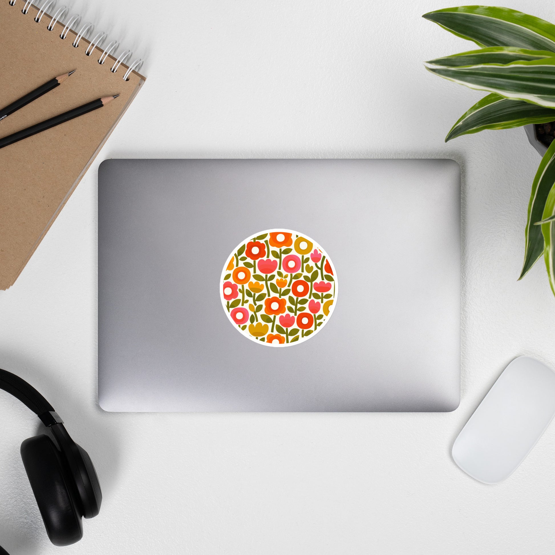 Retro 1970s flower power pattern vinyl sticker featuring geometric orange, pink, and yellow flowers with green leaves