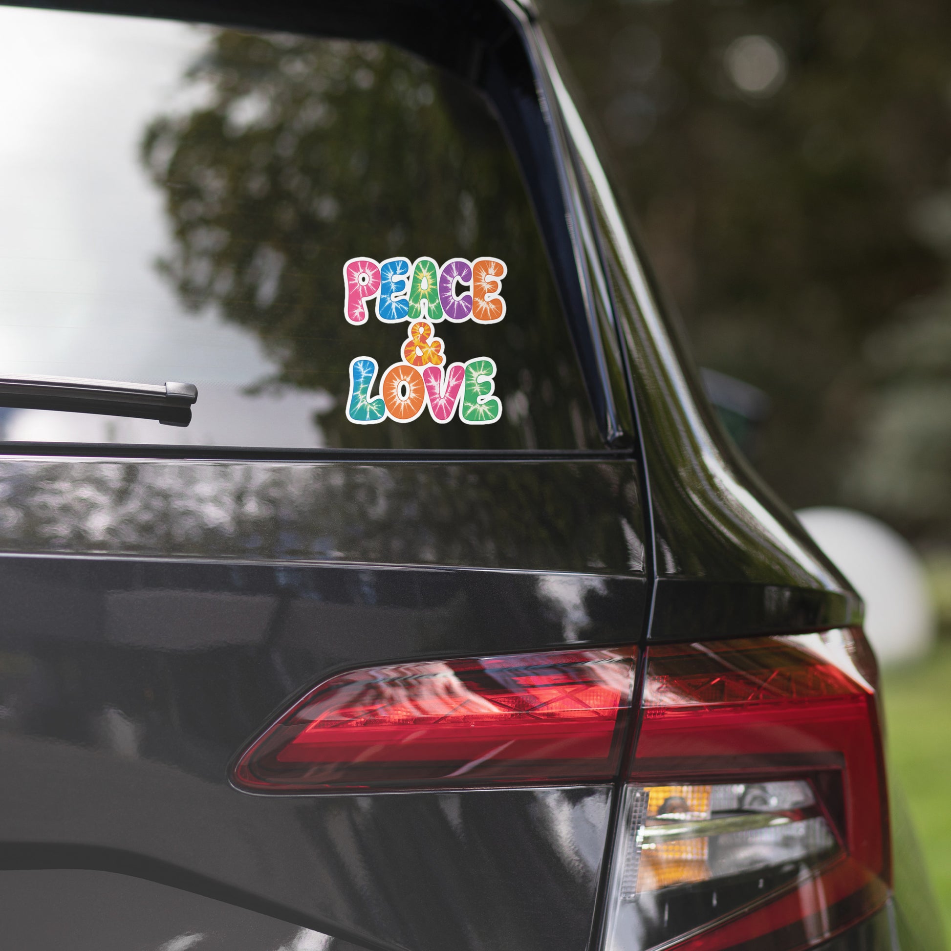 Colorful tie-dye Peace and Love lettering vinyl sticker in retro 60s and 70s vibrant rainbow font. Faroutgoods