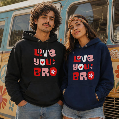 A man and a woman wearing matching graphic hoodies stand in front of a retro-style floral van. The man wears a black hoodie with pink, red, and white text reading 'LOVE YOU BRO' with a heart and flower motif.