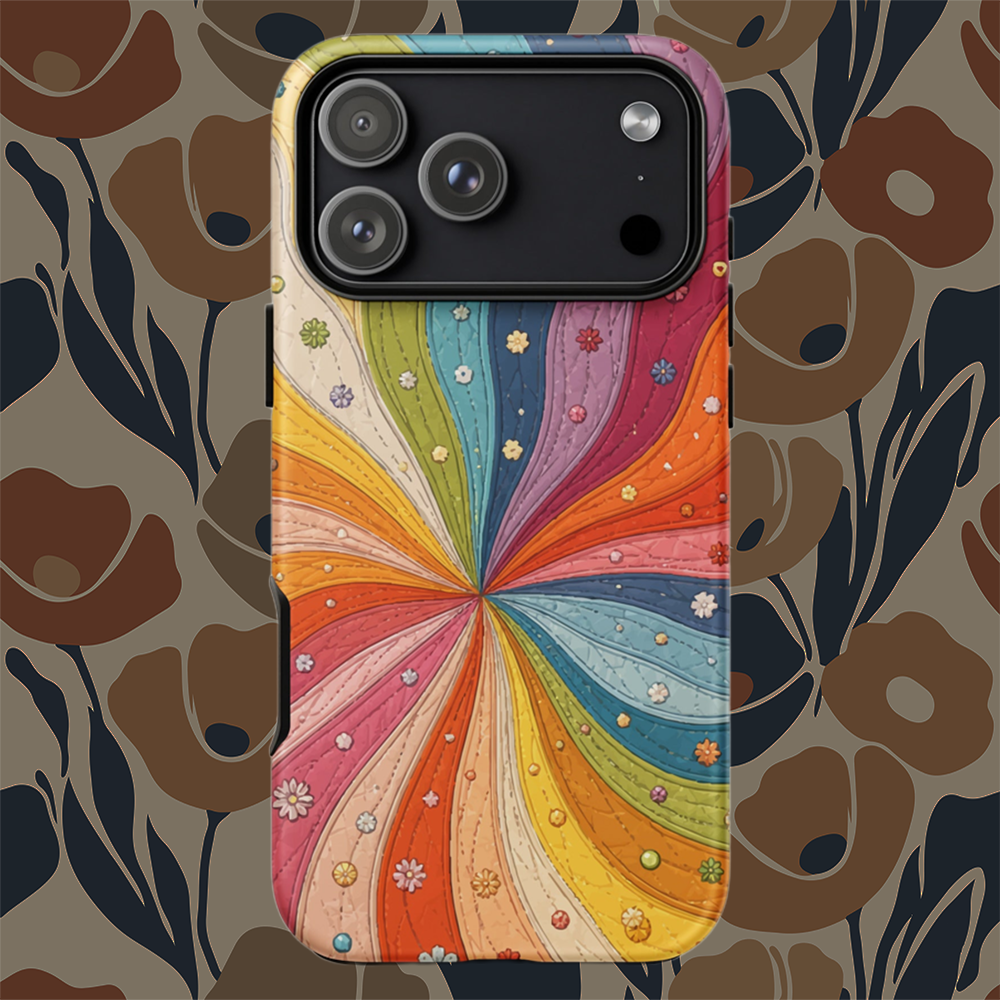 Flexible TPU iPhone case featuring a vibrant retro 70s quilted rainbow swirl design with stitched details and tiny flowers.