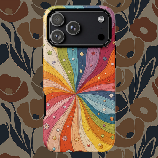 Flexible TPU iPhone case featuring a vibrant retro 70s quilted rainbow swirl design with stitched details and tiny flowers.