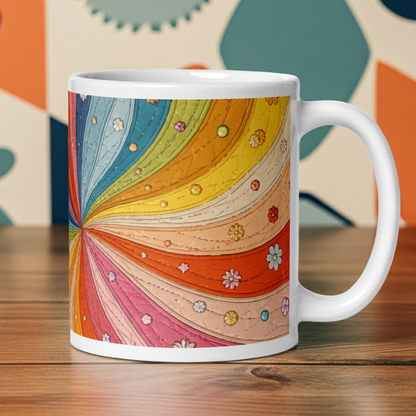Ceramic mug with a colorful retro 70s quilted rainbow swirl design featuring stitched details and small vintage flowers.