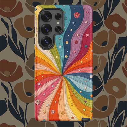 Flexible TPU Samsung Galaxy case featuring a vibrant retro 70s quilted rainbow swirl design with stitching and tiny flowers.