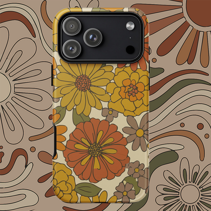 A flexible TPU iPhone case featuring a seamless retro groovy floral pattern with warm orange, yellow, and cream daisies.