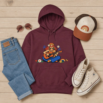 Unisex hoodie featuring a 70s-style illustration of a girl with long hair playing an acoustic guitar, framed by earthy boho flowers and a warm sunburst.