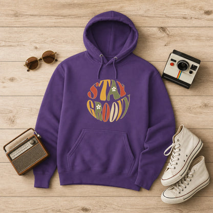 Unisex hoodie featuring a "Stay Groovy" vintage 70s floral design with vibrant orange and yellow flowers on a soft fabric base.