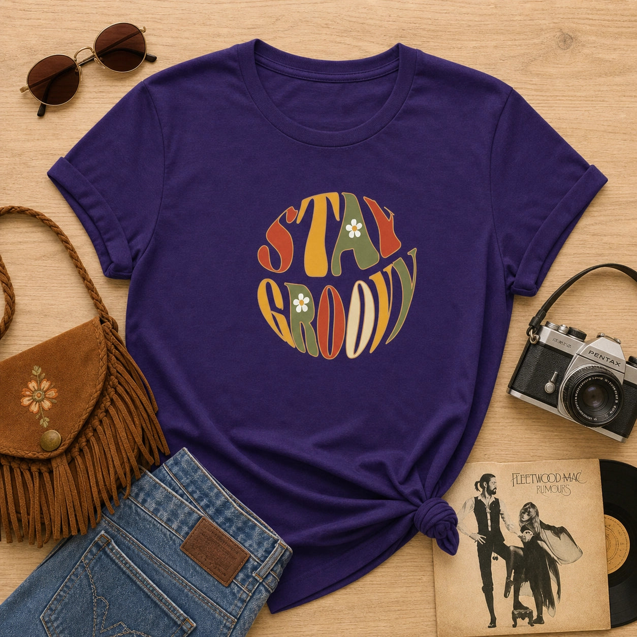 Unisex t-shirt featuring a Stay Groovy retro 70s floral design with vibrant orange and yellow flowers on a premium fabric.
