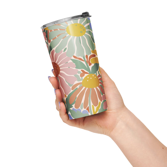 Retro 70s style flower power pattern with pink, green, and orange daisies on a bohemian insulated travel mug tumbler.