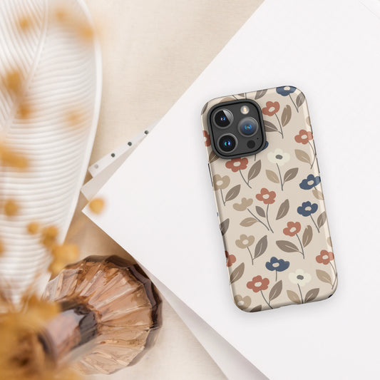 Dual-layer iPhone case featuring a retro mod flower pattern with large stylized blossoms in mustard yellow, burnt orange, and cream on a glossy finish.