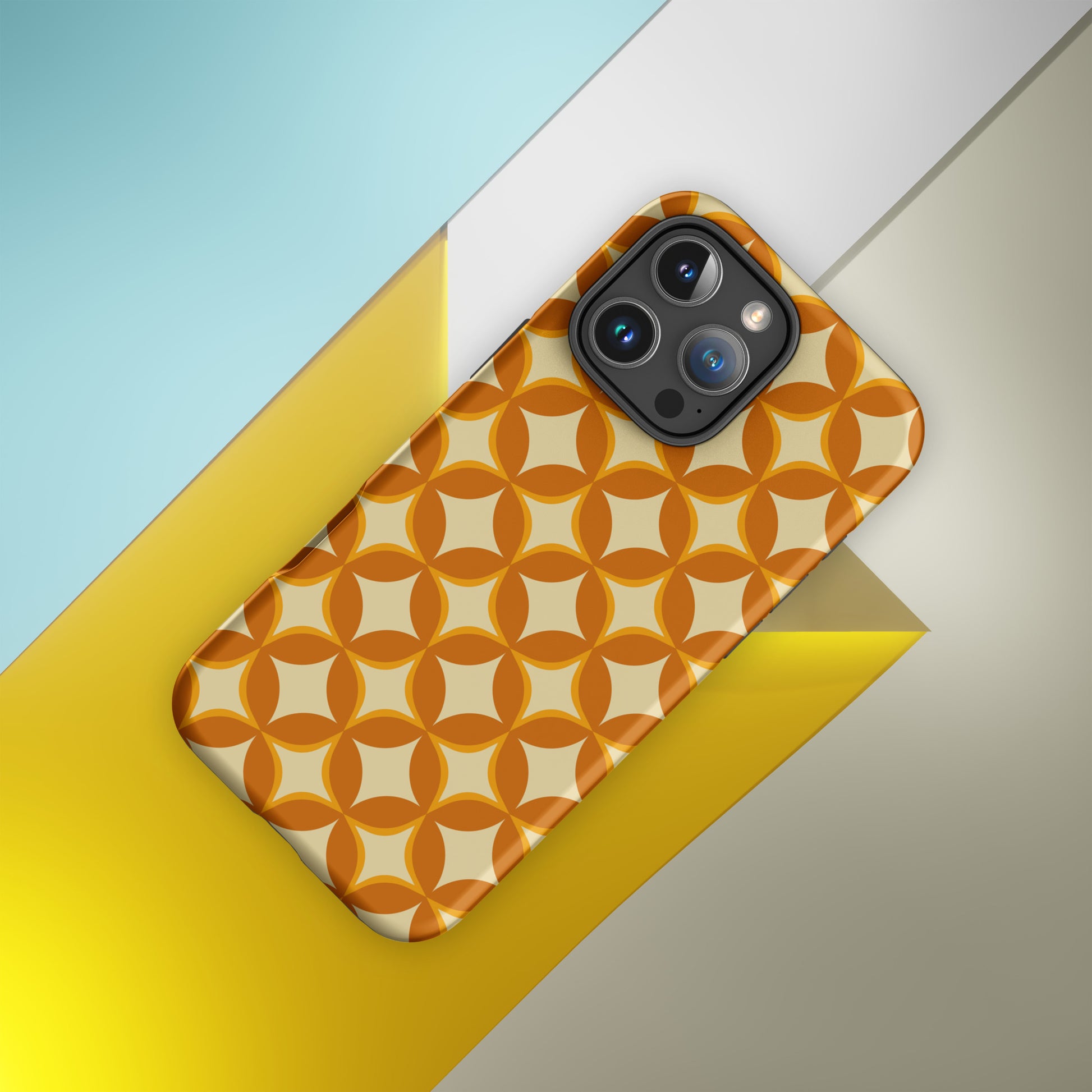Protective iPhone case featuring a 1970s retro geometric pattern of interlocking orange and mustard petal shapes.