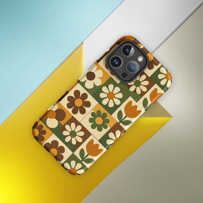TPU iPhone case featuring a 1970s retro floral tile pattern in orange, brown, and green by Far Out Goods.