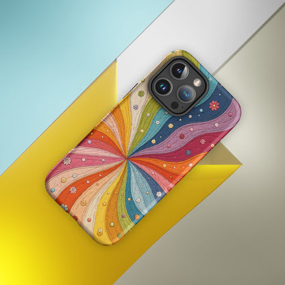 Flexible TPU iPhone case featuring a vibrant retro 70s quilted rainbow swirl design with stitched details and tiny flowers.