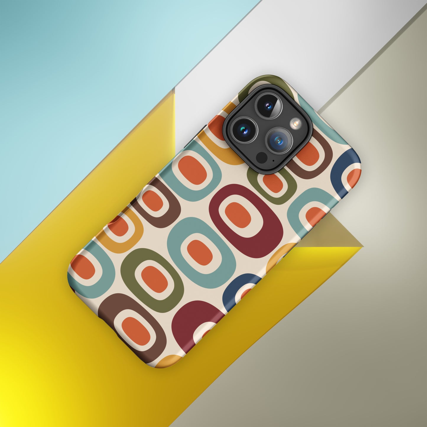 Retro 1970s mid-century modern geometric oval pattern TPU iPhone case featuring colorful mustard, orange, teal, and navy shapes