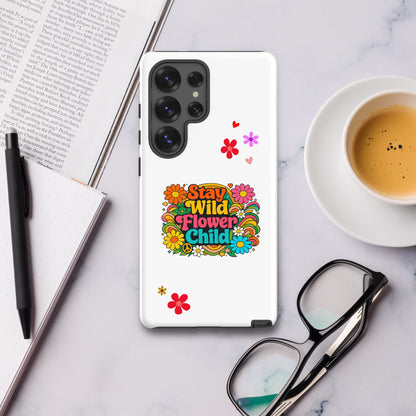 Stay Wild Flower Child retro 70s typography with bright pink and orange daisies on a Samsung Galaxy phone case.