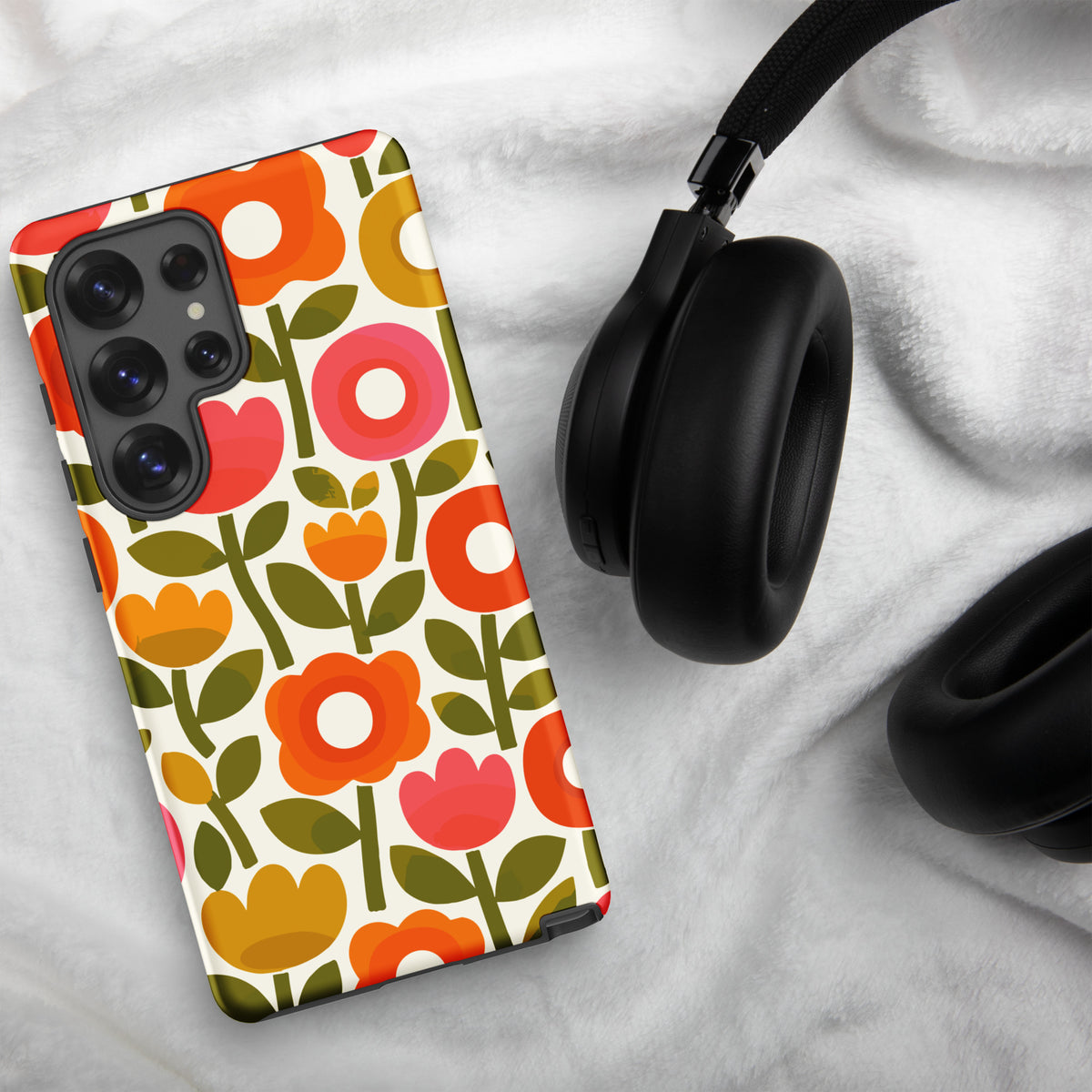 Retro 1970s flower power pattern TPU Samsung case featuring geometric orange, pink, and yellow flowers with green leaves