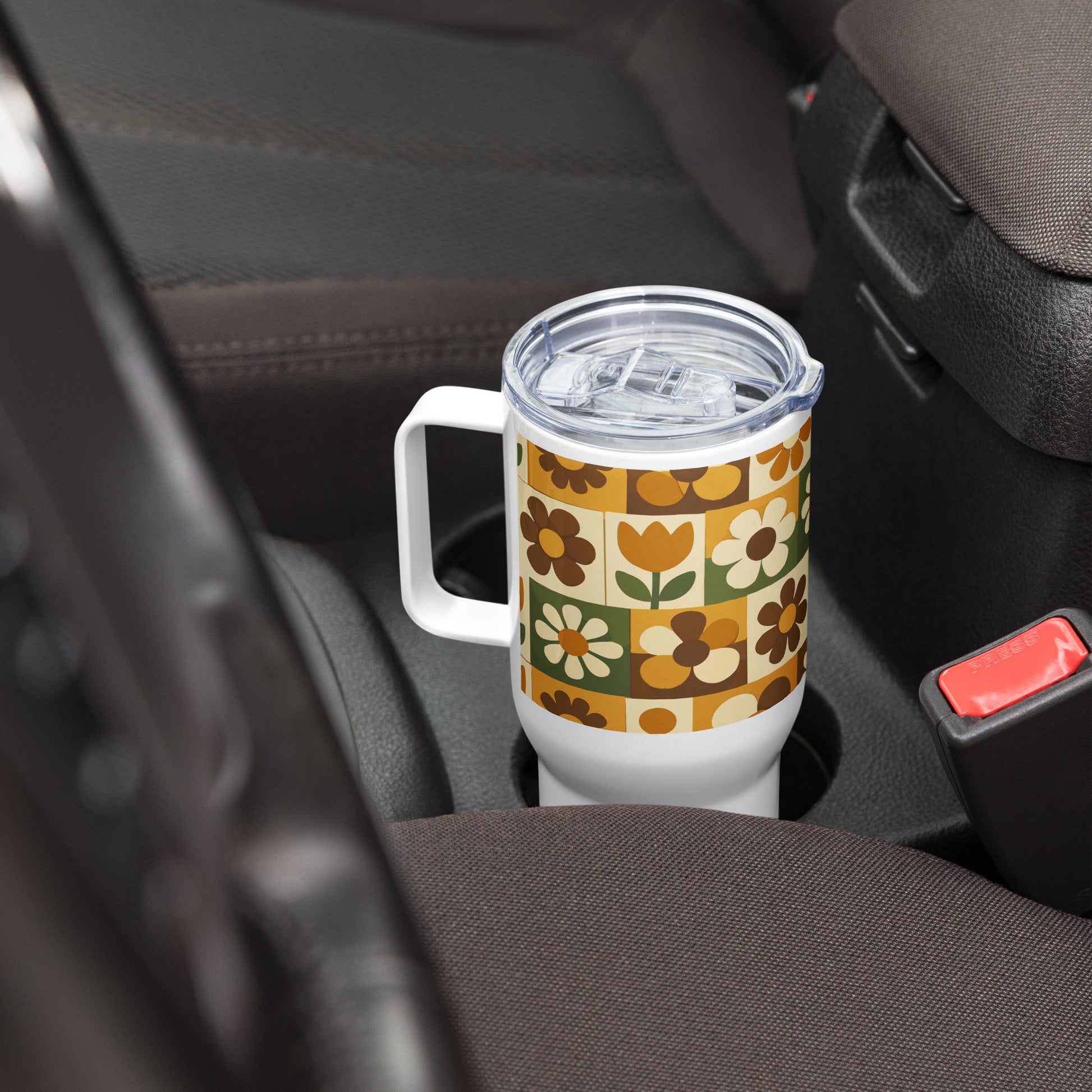 Stainless steel travel mug with a 1970s retro floral grid pattern of groovy flowers in orange, brown, and olive green.