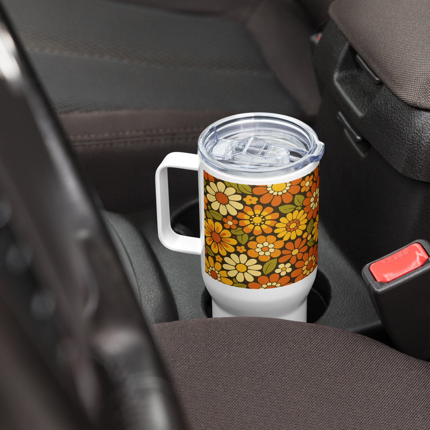 Retro 70s floral pattern stainless steel travel mug with orange, yellow, and cream daisies on a dark brown background.