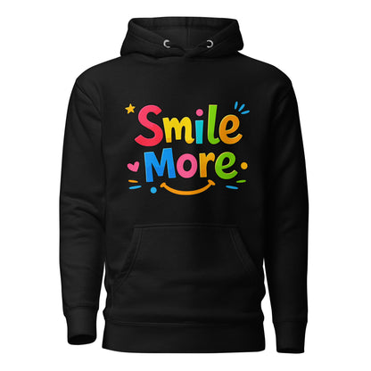 Smile More, bubbly lettering with a yellow sun-smile and pink heart on a black cozy hoodie.