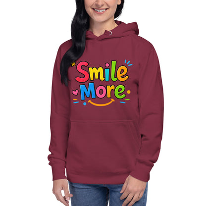 Smile More, bubbly lettering with a yellow sun-smile and pink heart on a black cozy hoodie.