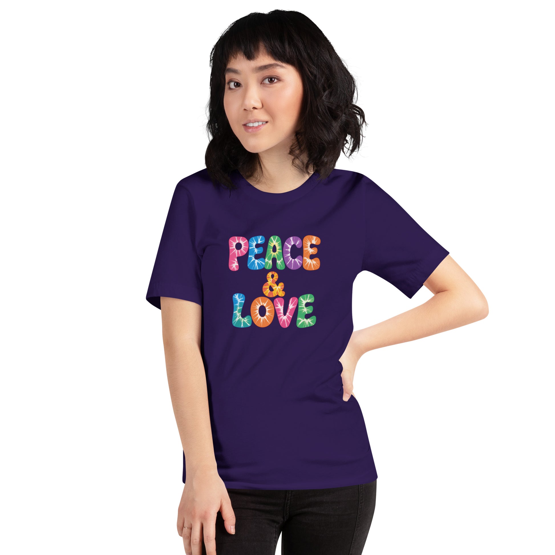 Retro tie-dye Peace and Love lettering printed on a classic black graphic t-shirt with vibrant 60s rainbow typography.