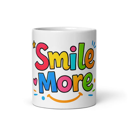Smile More, text in colorful bubbly letters with a sun-smile and pink heart on a black ceramic mug.