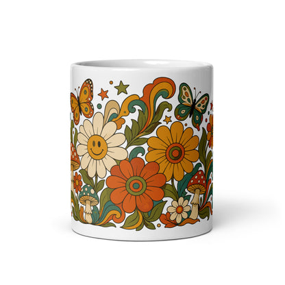 Retro 70s psychedelic ceramic mug featuring smiley daisies, red spotted mushrooms, and colorful butterflies.