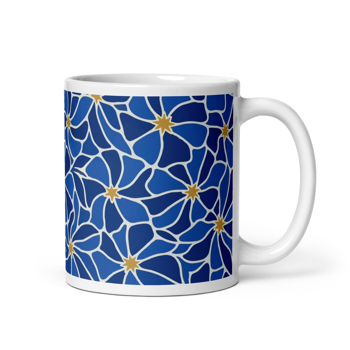 Ceramic coffee mug with a vibrant blue mosaic floral pattern and golden star centers by Far Out Goods.
