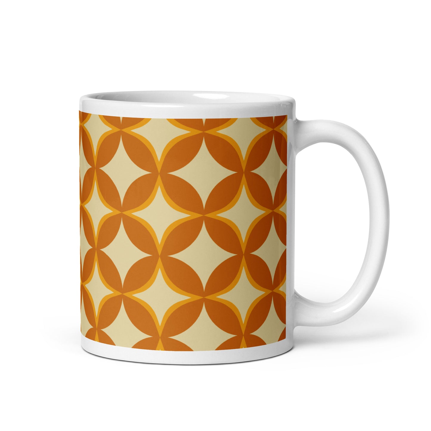 Ceramic coffee mug with a 1970s retro geometric pattern of interlocking orange and mustard petal shapes.
