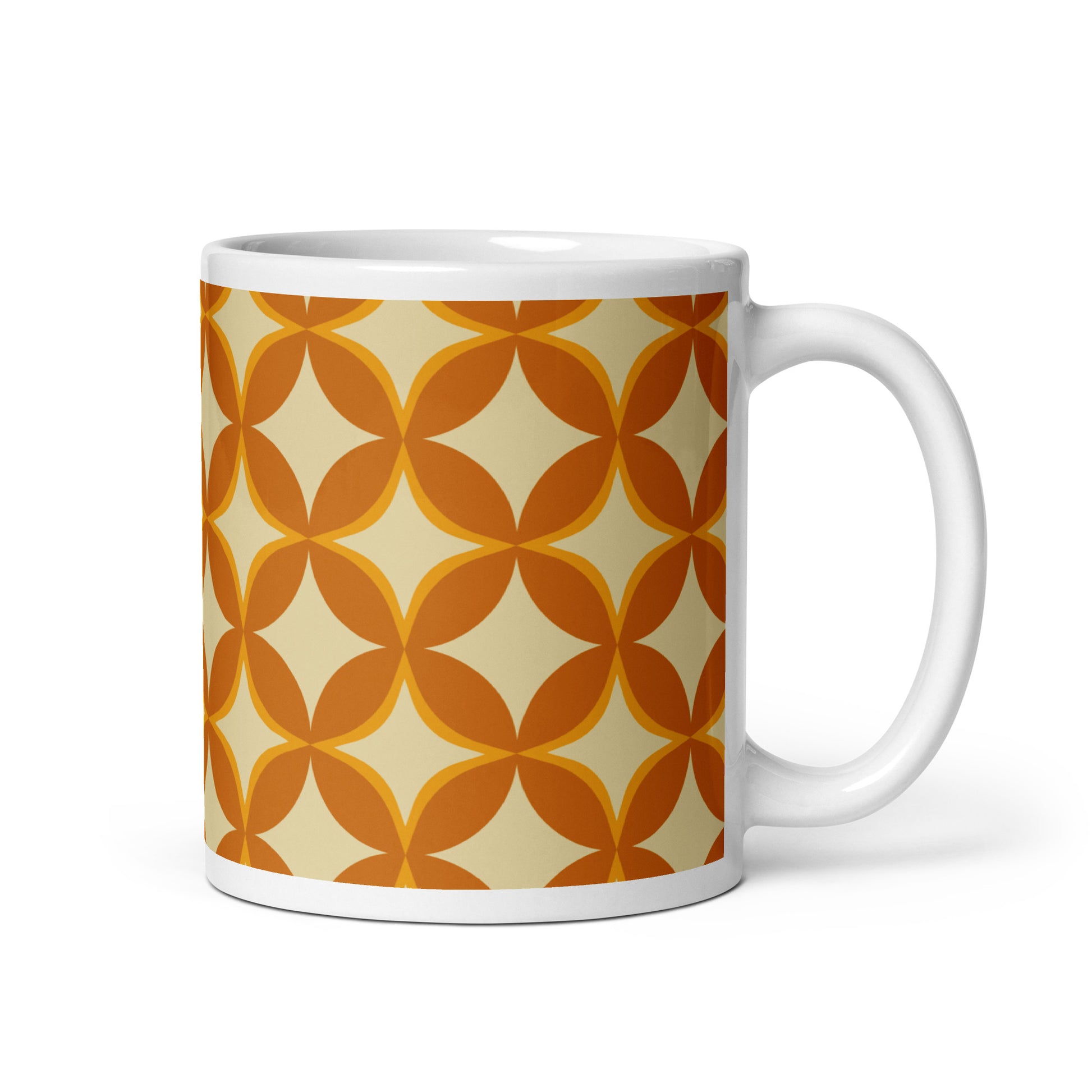 Ceramic coffee mug with a 1970s retro geometric pattern of interlocking orange and mustard petal shapes.