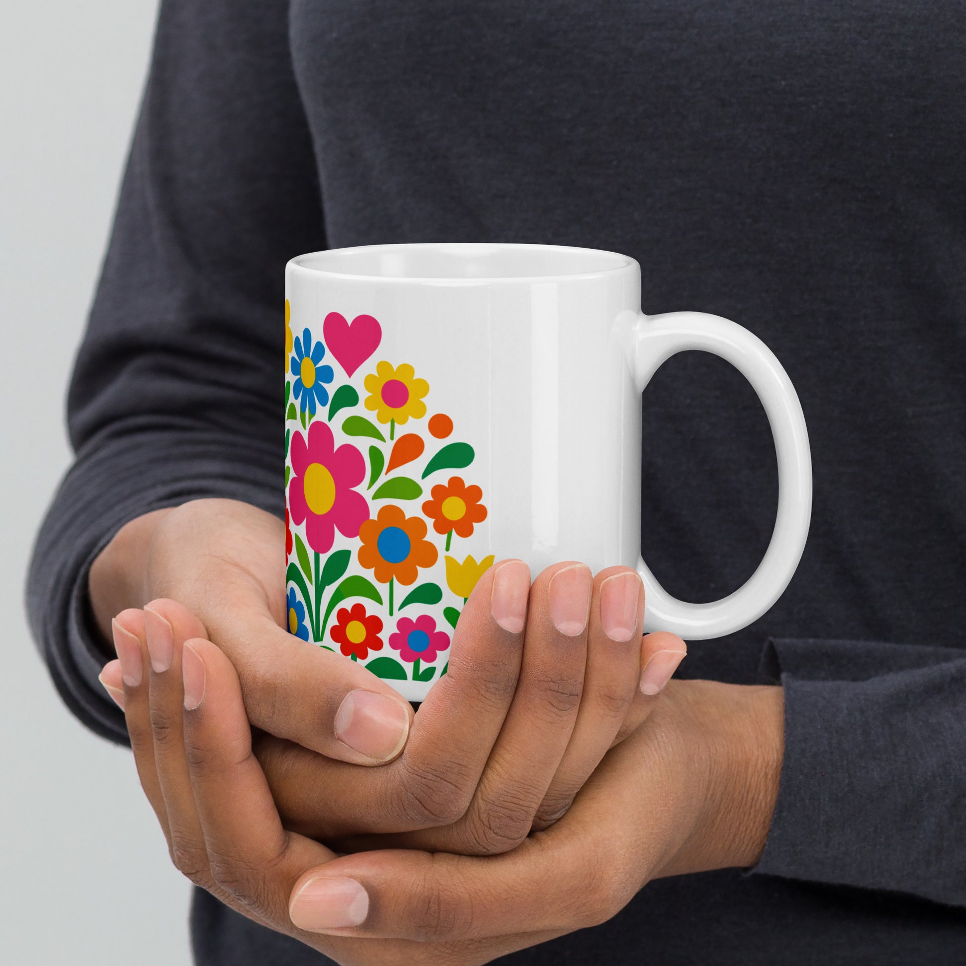 Vibrant 70s retro flower power bouquet with colorful blooms and pink and red hearts on a white ceramic mug.