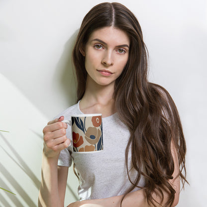 Ceramic coffee mug printed with a seamless retro floral pattern in earthy terracotta, ochre, and deep navy blue.