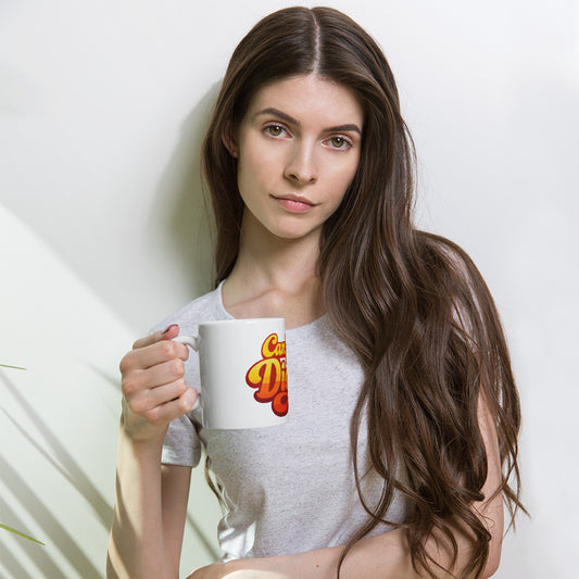Retro sunset gradient typography reading Can You Dig It in bold orange and yellow groovy letters on a ceramic mug.