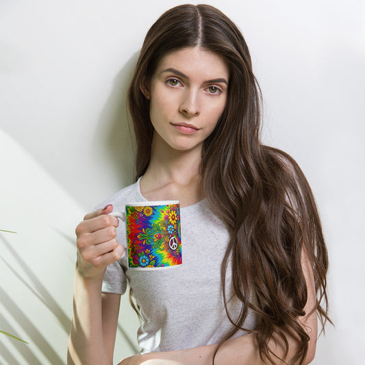 Psychedelic tie dye ceramic mug with vibrant rainbow swirls, peace signs, retro sunflowers, daisies, and butterflies.