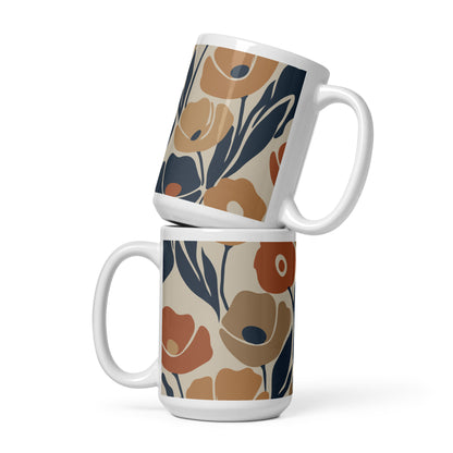 Ceramic coffee mug printed with a seamless retro floral pattern in earthy terracotta, ochre, and deep navy blue.
