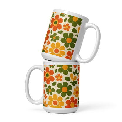 Groovy 1970s retro flower power pattern printed on a ceramic coffee mug with vibrant orange and yellow daisy graphics.
