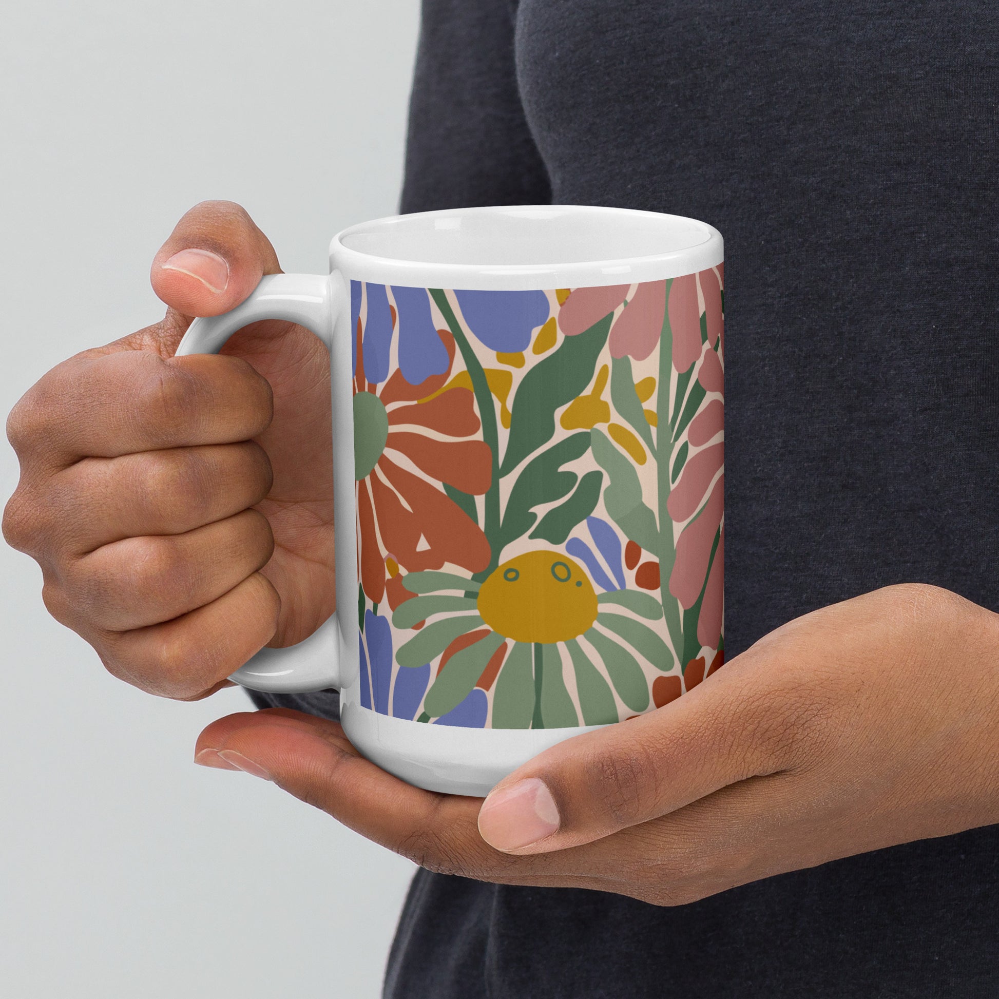 Retro 70s style flower power pattern with pink, green, and orange daisies on a bohemian ceramic coffee mug.