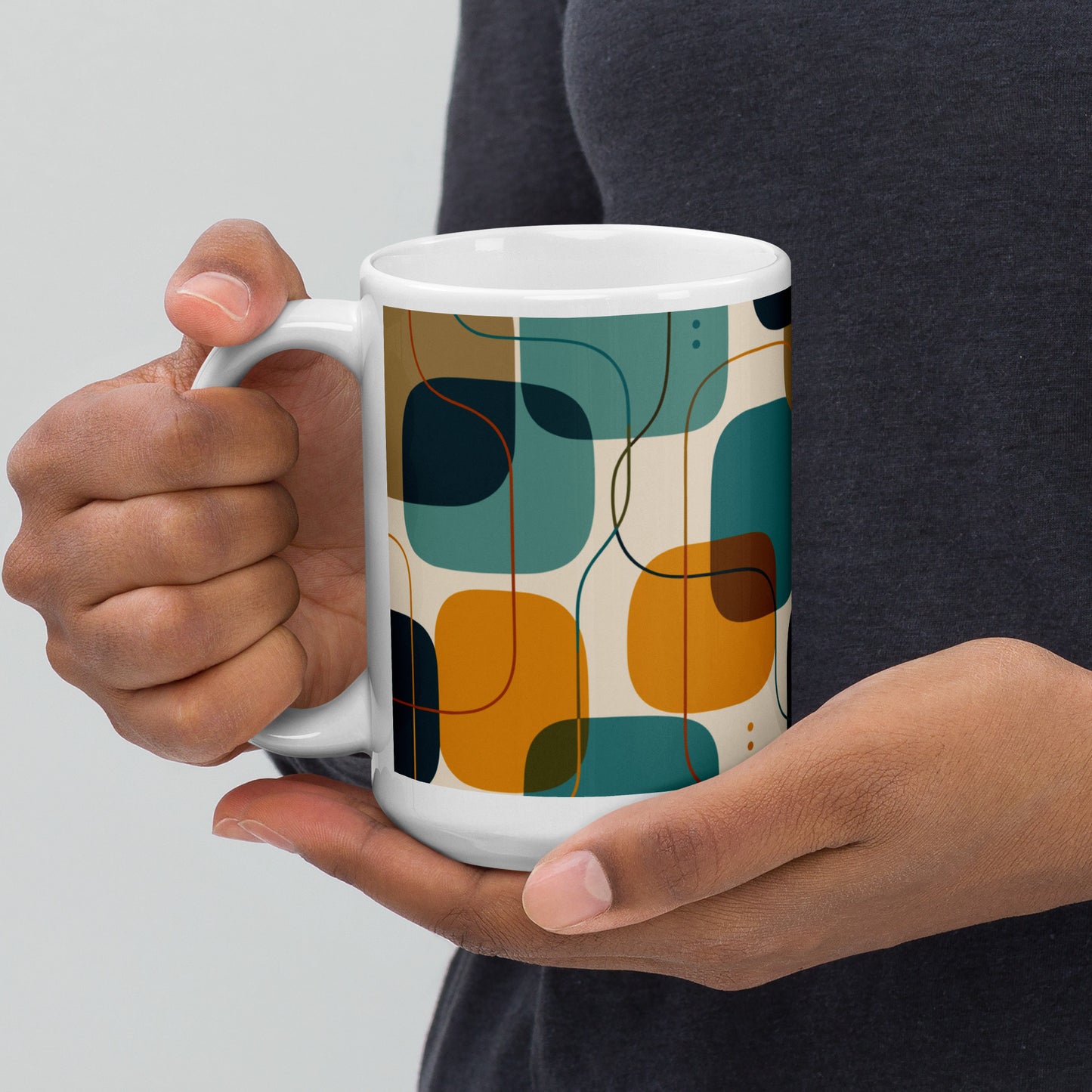 Retro geometric ceramic coffee mug featuring mid-century rounded squares and lines in teal, mustard yellow, and orange.