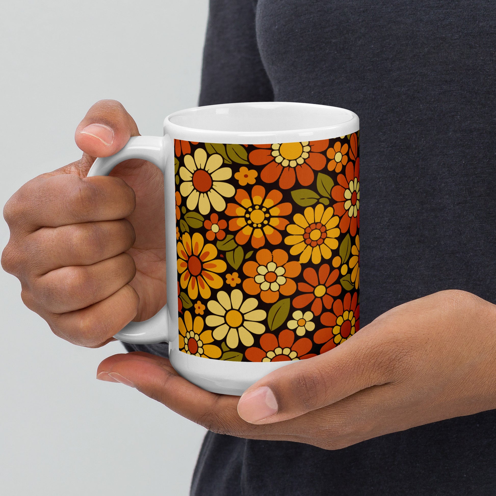 Retro 70s floral pattern ceramic mug featuring orange, yellow, and cream daisies on a dark brown background.