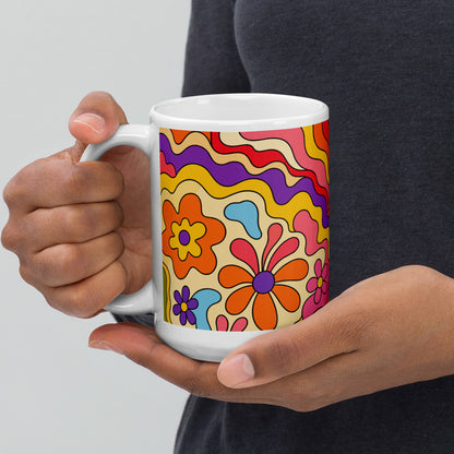 Vibrant 1970s psychedelic ceramic mug featuring a wavy retro sunburst sunset surrounded by colorful groovy flowers.