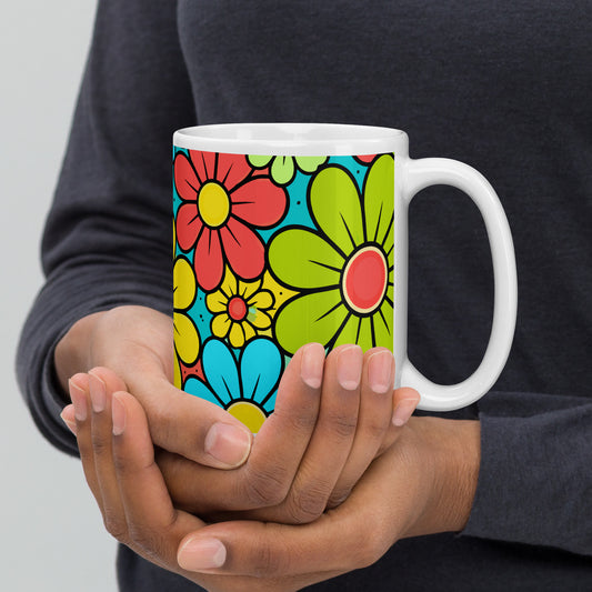 Vibrant retro 70s flower power pattern with teal, yellow, and red blossoms on a colorful floral ceramic mug.
