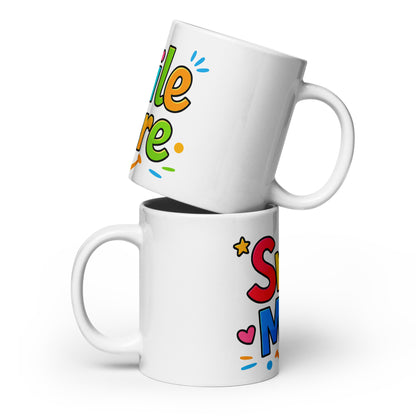 Smile More, text in colorful bubbly letters with a sun-smile and pink heart on a black ceramic mug.